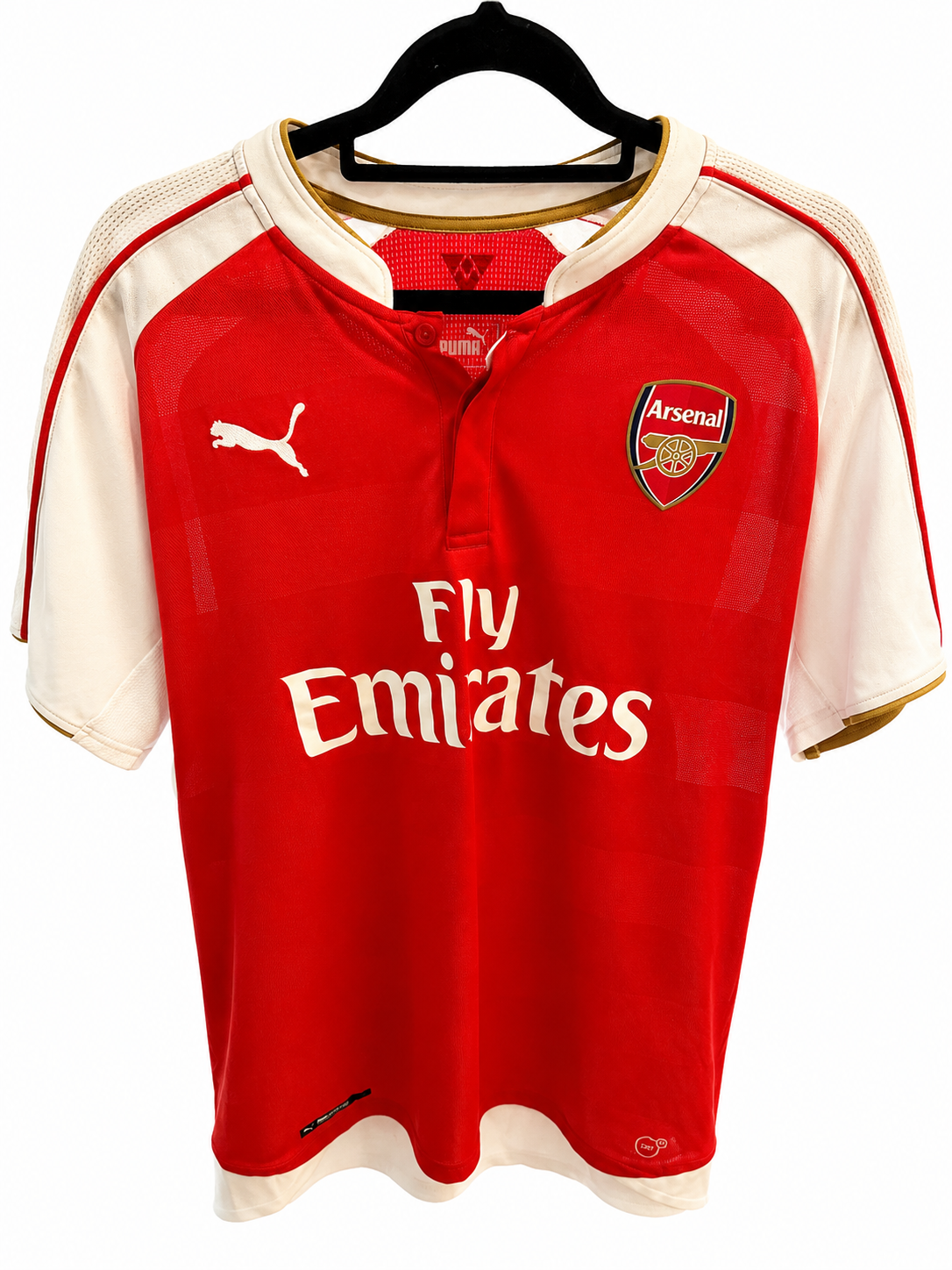 A red and white Arsenal home soccer jersey by Puma, hanging on a black hanger against a white background. The jersey features the Arsenal club crest on the left chest, the Puma logo on the right chest, and 'Fly Emirates' printed across the front.